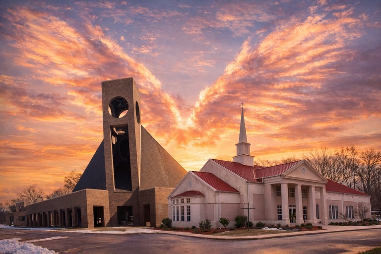 Modern church building under dramatic sunset sky