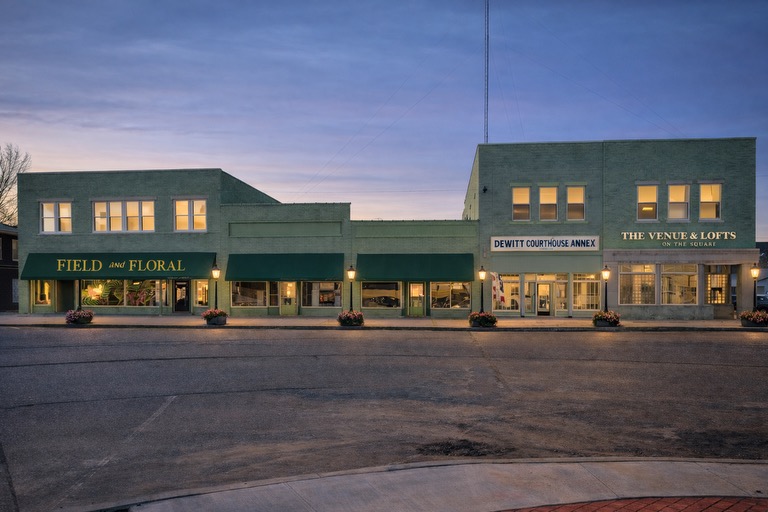 Field and Floral, DeWitt Courthouse Annex, and The Venue and Lofts evening storefront showcasing downtown revitalization and thriving local businesses
